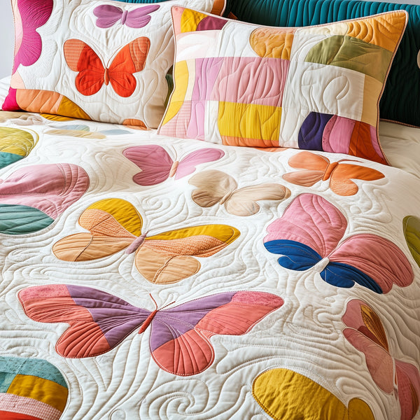 Butterfly quilted 3-piece bedding set on a made bed with two matching pillow shams