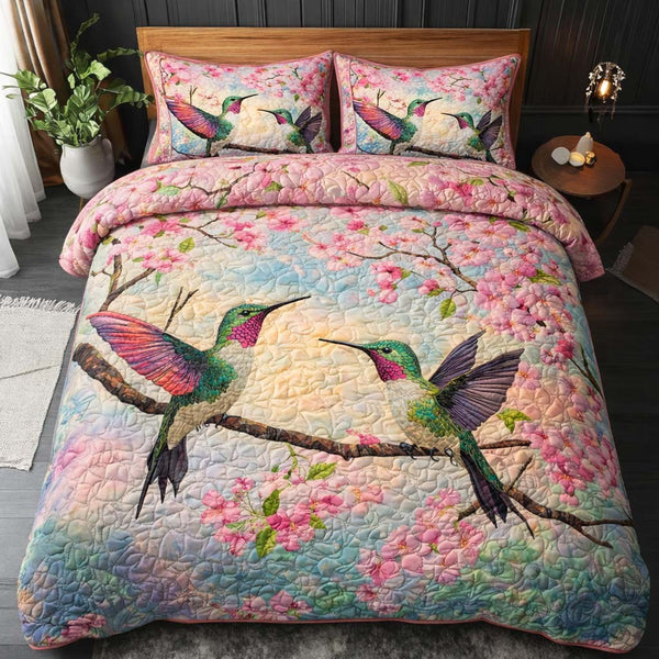 Blossom Flight quilted 3-piece bedding set on a made bed with two matching pillow shams