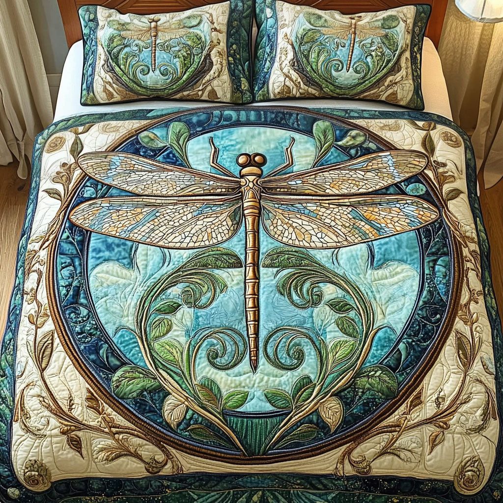 Aqua Dragonfly quilted 3-piece bedding set on a made bed with two matching pillow shams