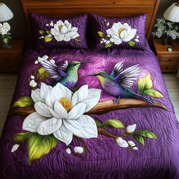 Birds in Bloom quilted 3-piece bedding set on a made bed with two matching pillow shams
