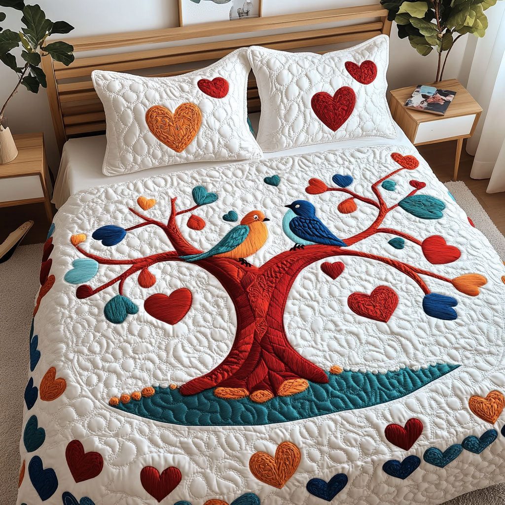 Birdsong Bliss quilted 3-piece bedding set on a made bed with two matching pillow shams