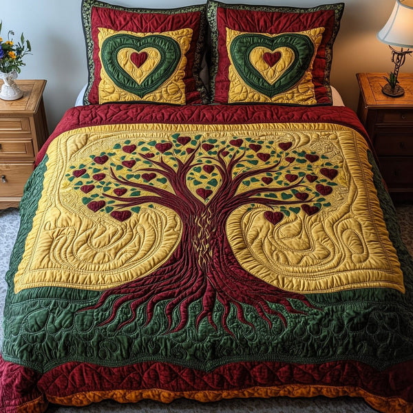 Black History Tree quilted 3-piece bedding set on a made bed with two matching pillow shams
