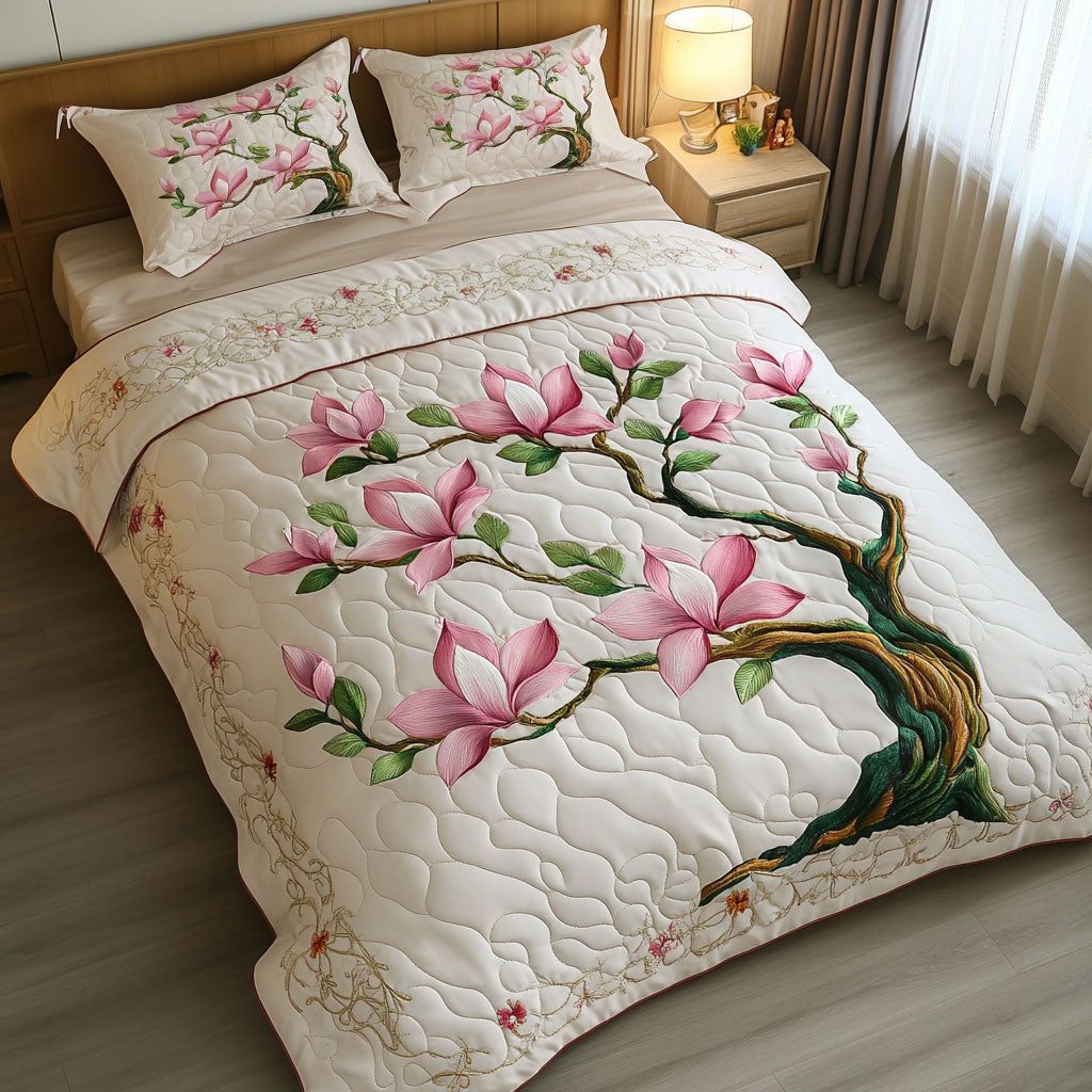 Blooming Magnolia Bliss quilted 3-piece bedding set on a made bed with two matching pillow shams