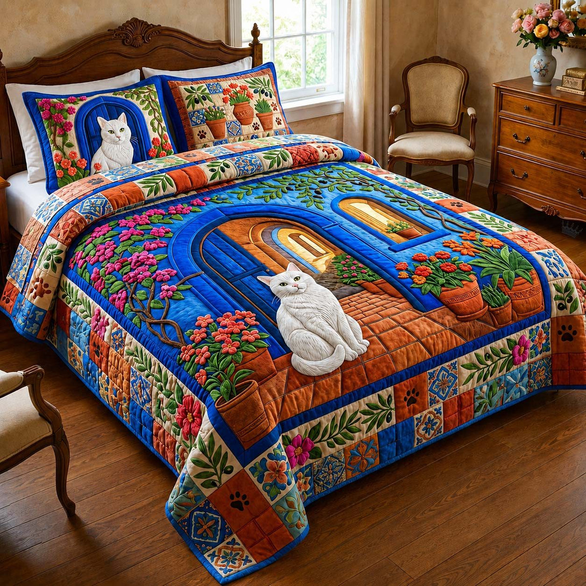 Blue Garden Cat quilted 3-piece bedding set on a made bed with two matching pillow shams