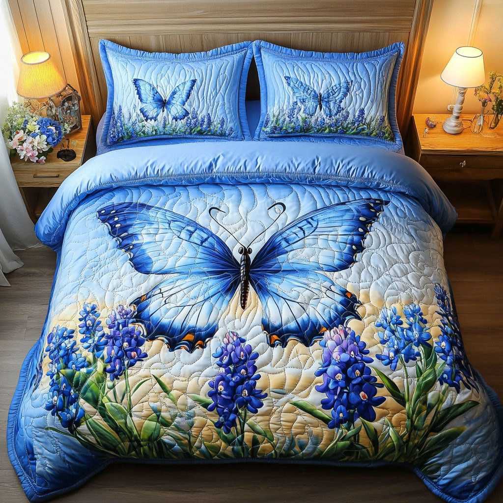 Bluebonnet Wings quilted 3-piece bedding set on a made bed with two matching pillow shams