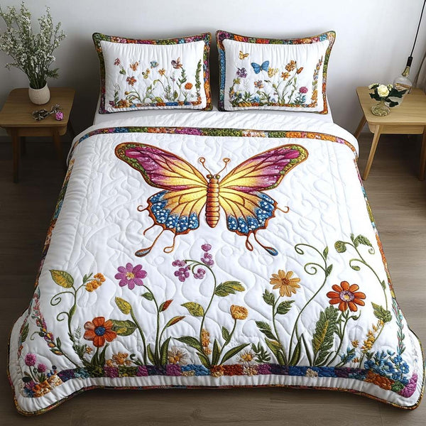 Butterfly Meadow quilted 3-piece bedding set on a made bed with two matching pillow shams