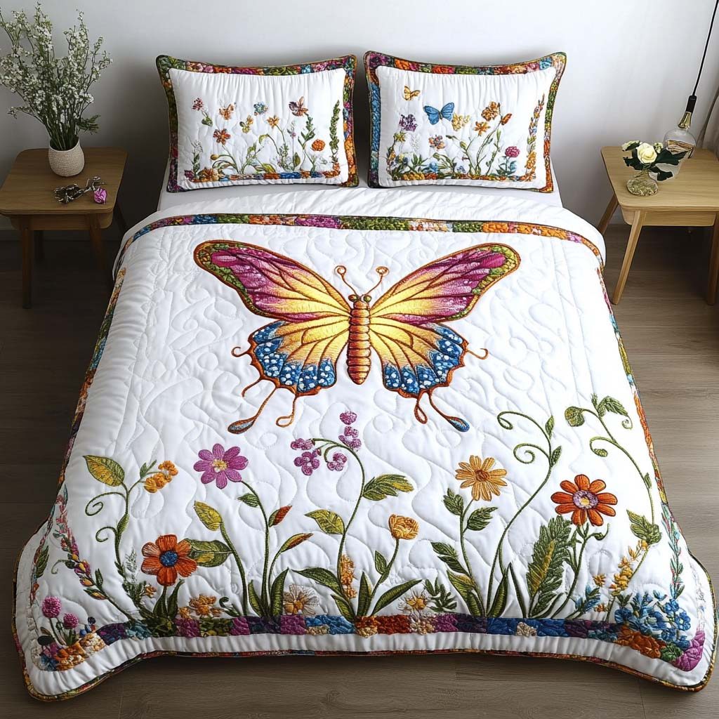 Butterfly Meadow quilted 3-piece bedding set on a made bed with two matching pillow shams