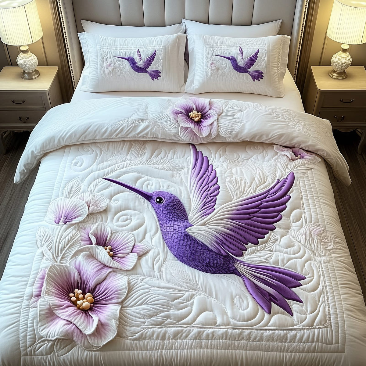 Charming Hummingbird quilted 3-piece bedding set on a made bed with two matching pillow shams