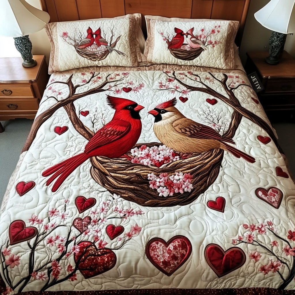 Couple Cardinal quilted 3-piece bedding set on a made bed with two matching pillow shams
