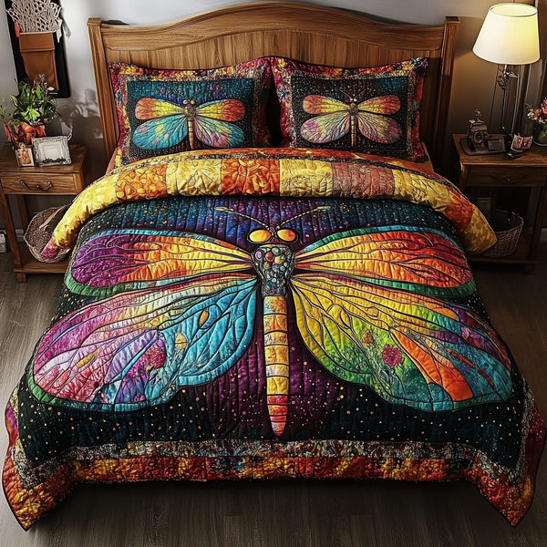 Dragonfly Dream quilted 3-piece bedding set on a made bed with two matching pillow shams