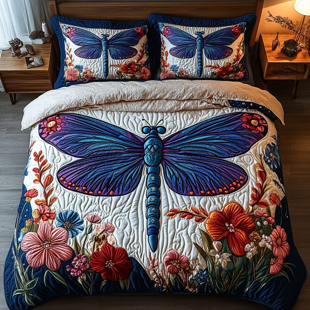 Dragonfly Joy quilted 3-piece bedding set on a made bed with two matching pillow shams