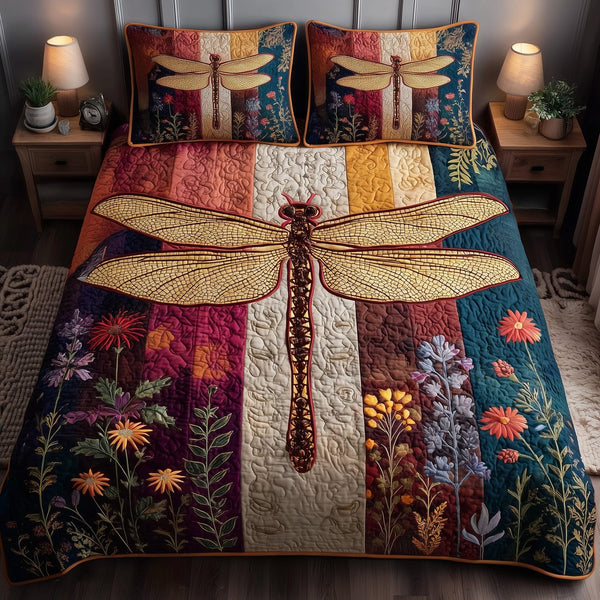 Dragonfly Serenity quilted 3-piece bedding set on a made bed with two matching pillow shams