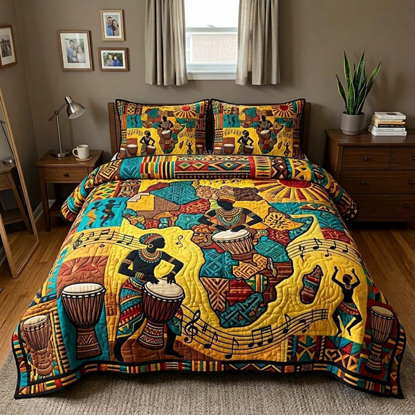 Drum Legacy quilted 3-piece bedding set on a made bed with two matching pillow shams