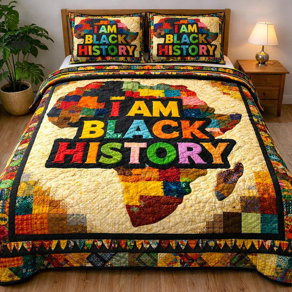 Ebony Glow quilted 3-piece bedding set on a made bed with two matching pillow shams