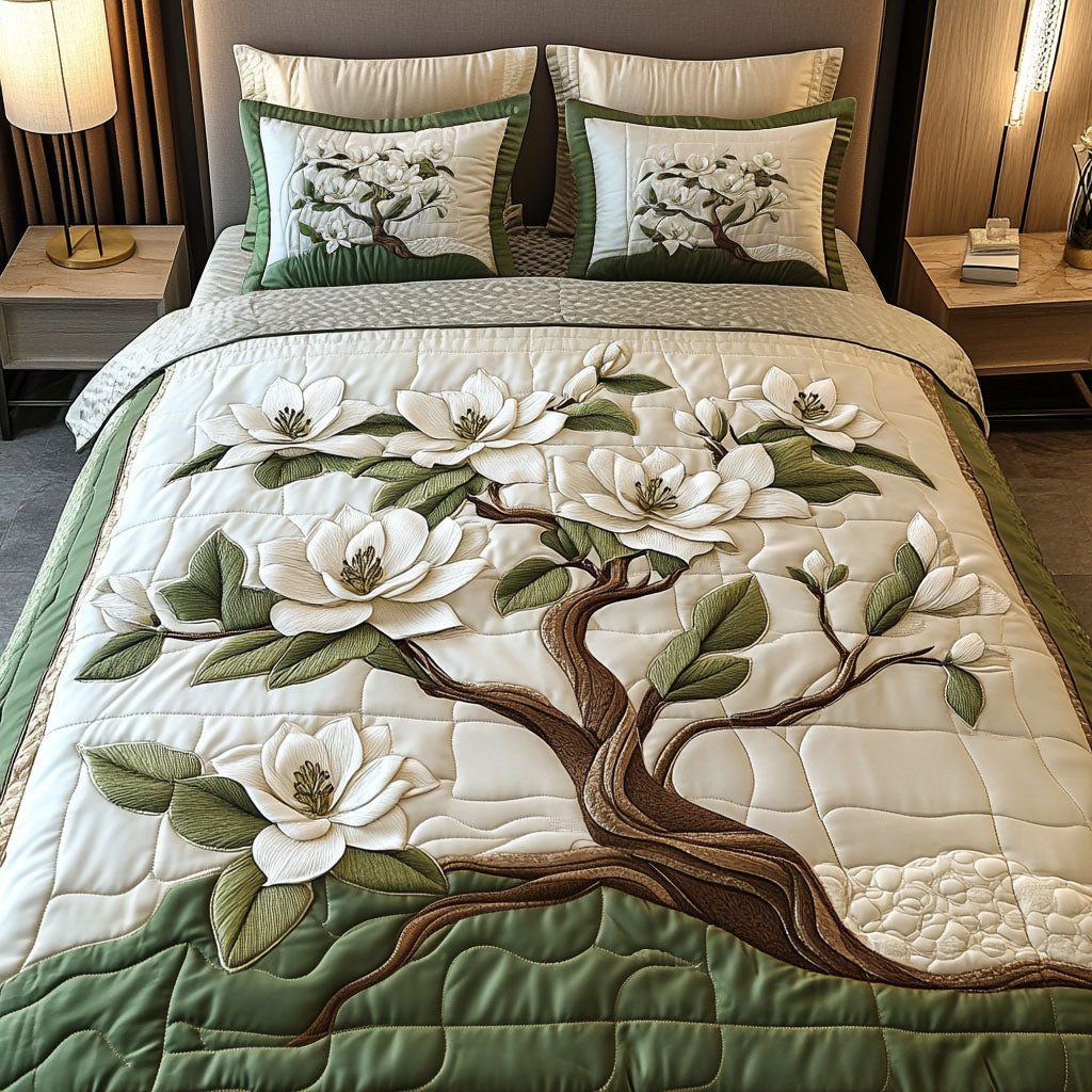 Elegant White Magnolia quilted 3-piece bedding set on a made bed with two matching pillow shams