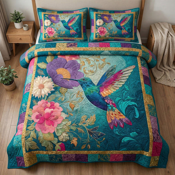 Emerald Hummingbird quilted 3-piece bedding set on a made bed with two matching pillow shams