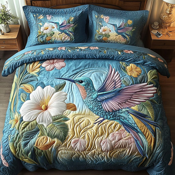 Floral Flight quilted 3-piece bedding set on a made bed with two matching pillow shams