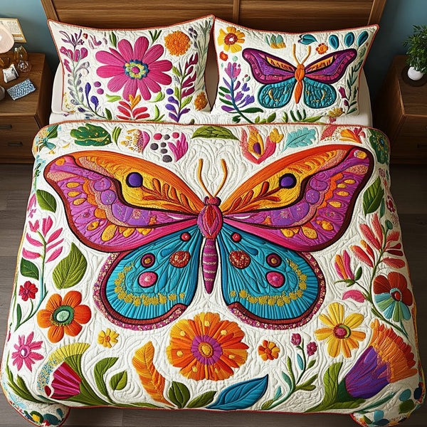 Floral Wings quilted 3-piece bedding set on a made bed with two matching pillow shams