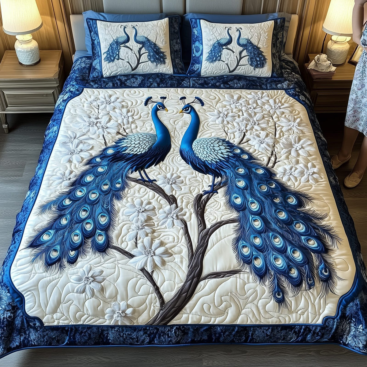 Happily Ever Peacocks quilted 3-piece bedding set on a made bed with two matching pillow shams
