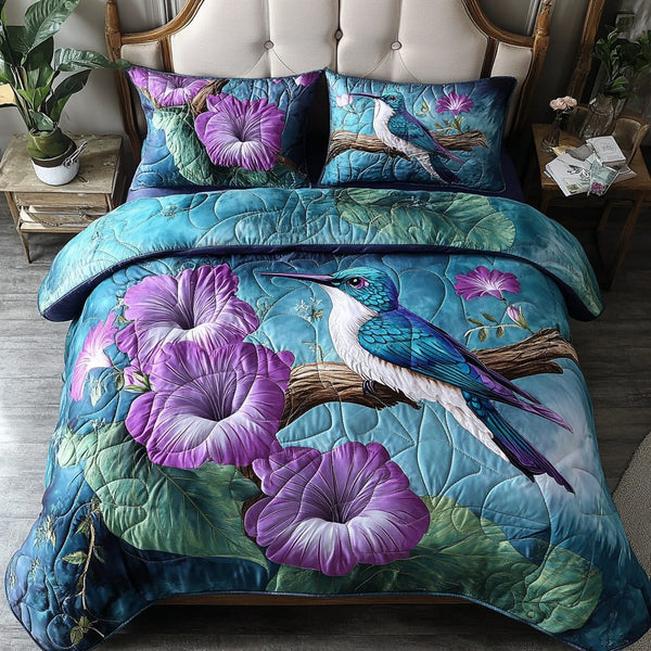 Humming Grace quilted 3-piece bedding set on a made bed with two matching pillow shams