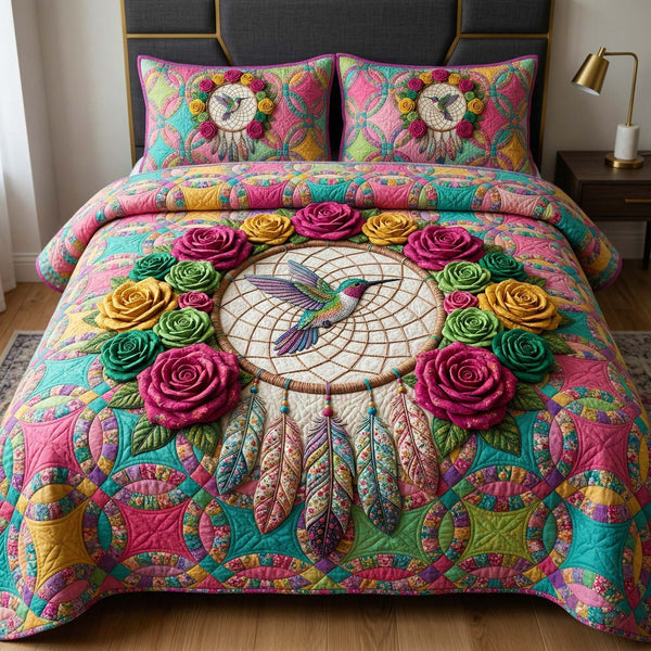 Hummingbird Bloom quilted 3-piece bedding set on a made bed with two matching pillow shams