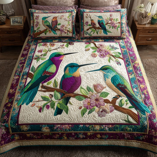 Hummingbird Harmony quilted 3-piece bedding set on a made bed with two matching pillow shams