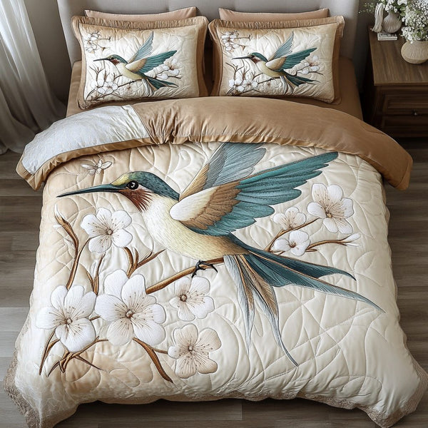 Hummingbird Haven quilted 3-piece bedding set on a made bed with two matching pillow shams