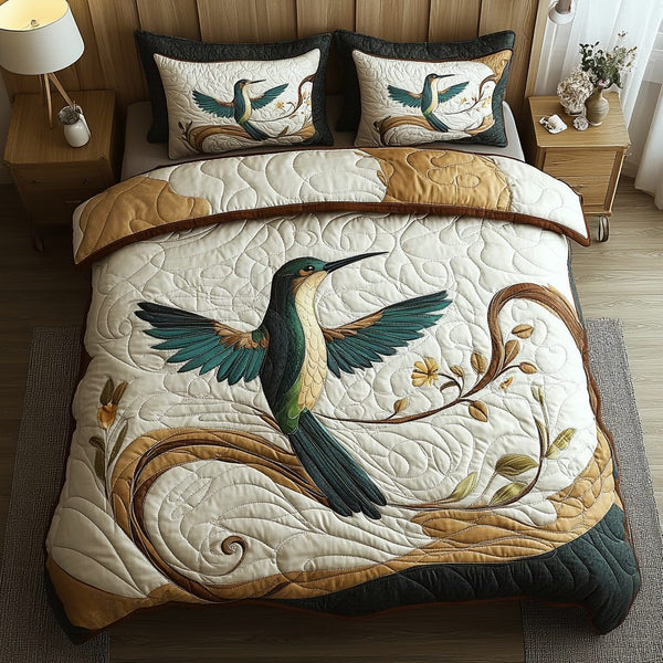 Hummingbird Haven quilted 3-piece bedding set on a made bed with two matching pillow shams