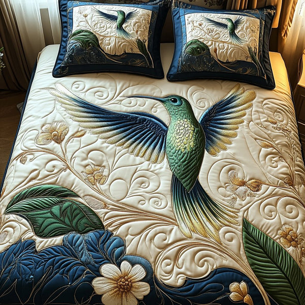 Hummingbird Haven quilted 3-piece bedding set on a made bed with two matching pillow shams