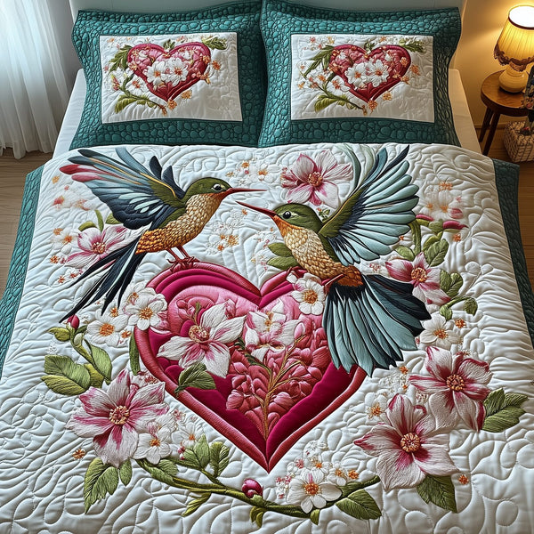 Hummingbird Love quilted 3-piece bedding set on a made bed with two matching pillow shams