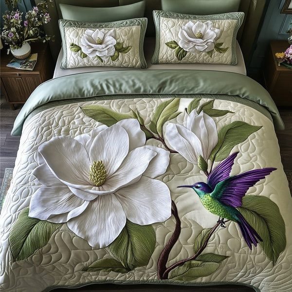 Hummingbird quilted 3-piece bedding set on a made bed with two matching pillow shams