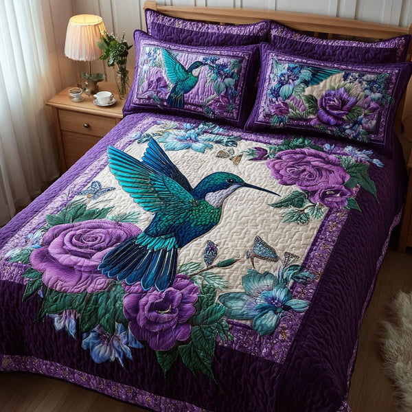 Hummingbird Serenade quilted 3-piece bedding set on a made bed with two matching pillow shams