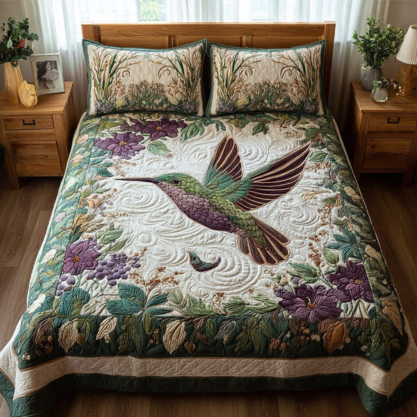 Hummingbird Song quilted 3-piece bedding set on a made bed with two matching pillow shams