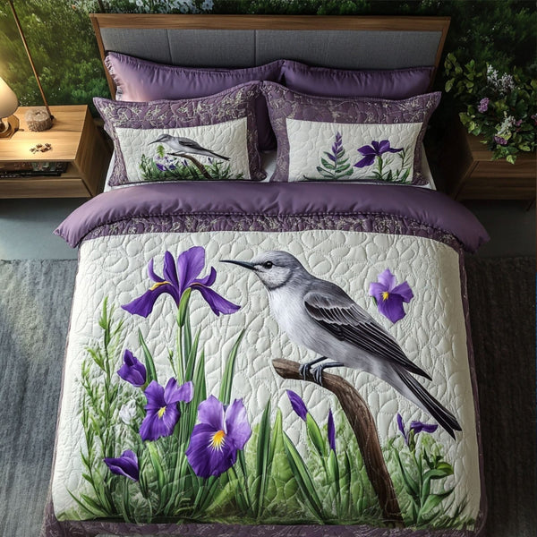 Iris Blossom Harmony quilted 3-piece bedding set on a made bed with two matching pillow shams
