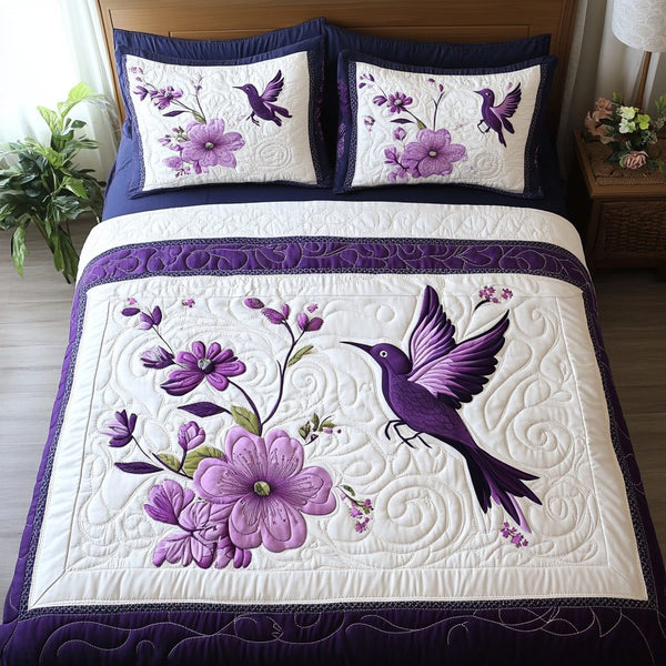 Lavender and Beaks quilted 3-piece bedding set on a made bed with two matching pillow shams