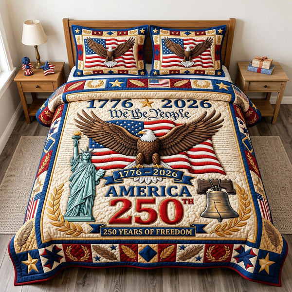 Liberty Legacy quilted 3-piece bedding set on a made bed in a warmly lit bedroom