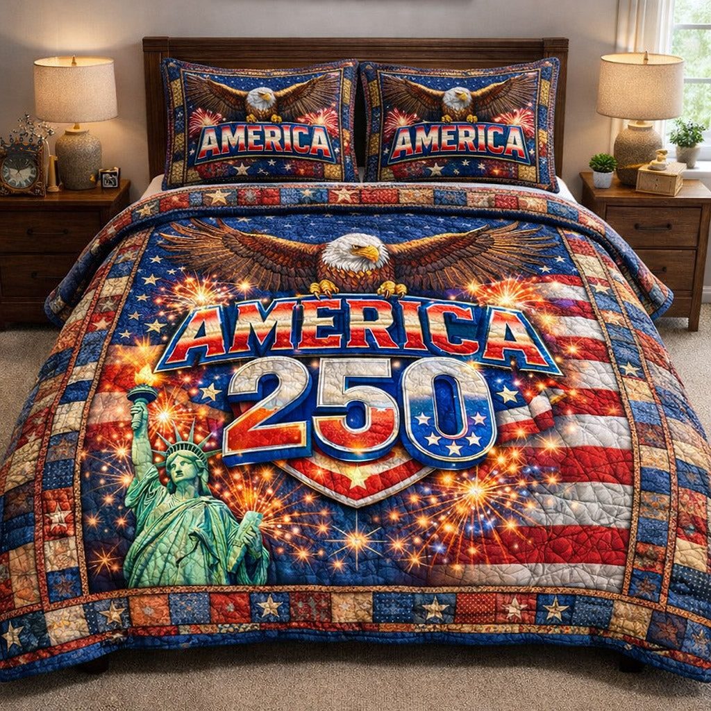 Liberty Legacy quilted 3-piece bedding set on a made bed in a warmly lit bedroom
