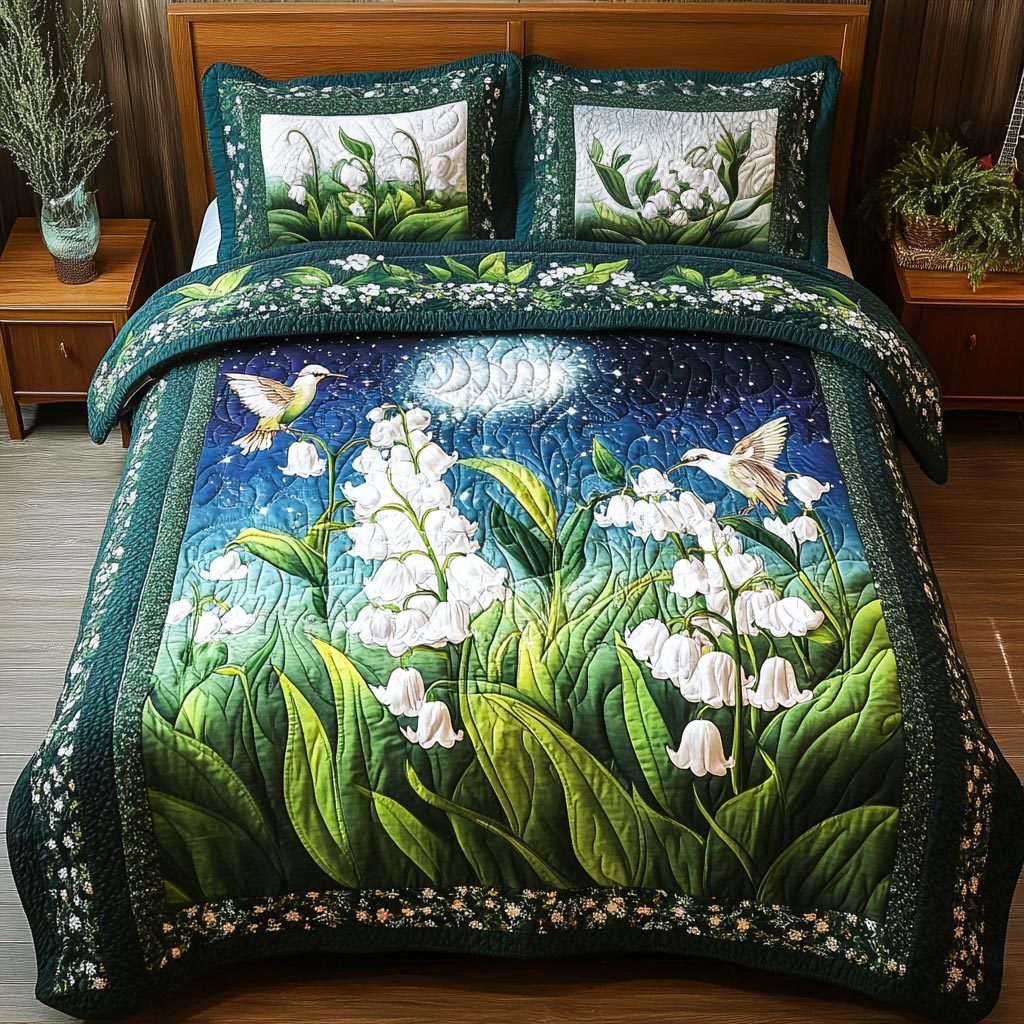 Lily Hummingbird quilted 3-piece bedding set on a made bed with two matching pillow shams