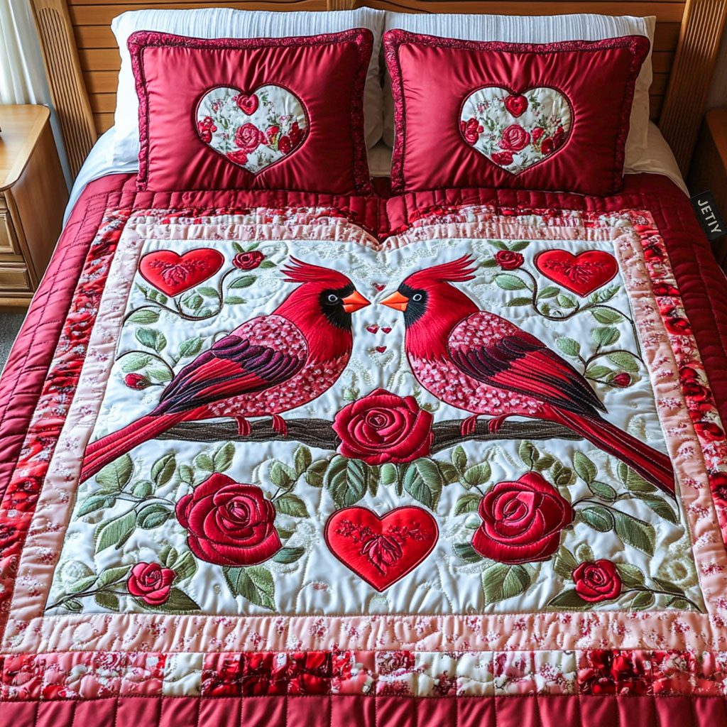 Love Unleashed quilted 3-piece bedding set on a made bed with two matching pillow shams