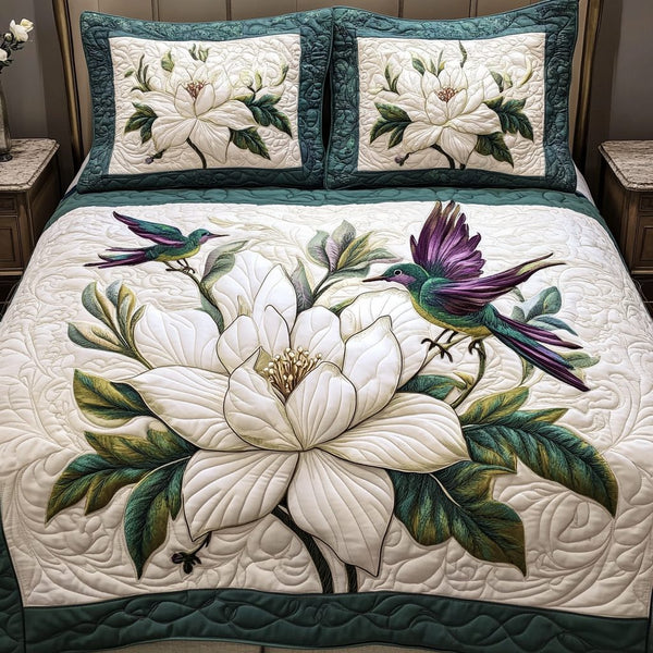 Magnolia Bliss quilted 3-piece bedding set on a made bed with two matching pillow shams