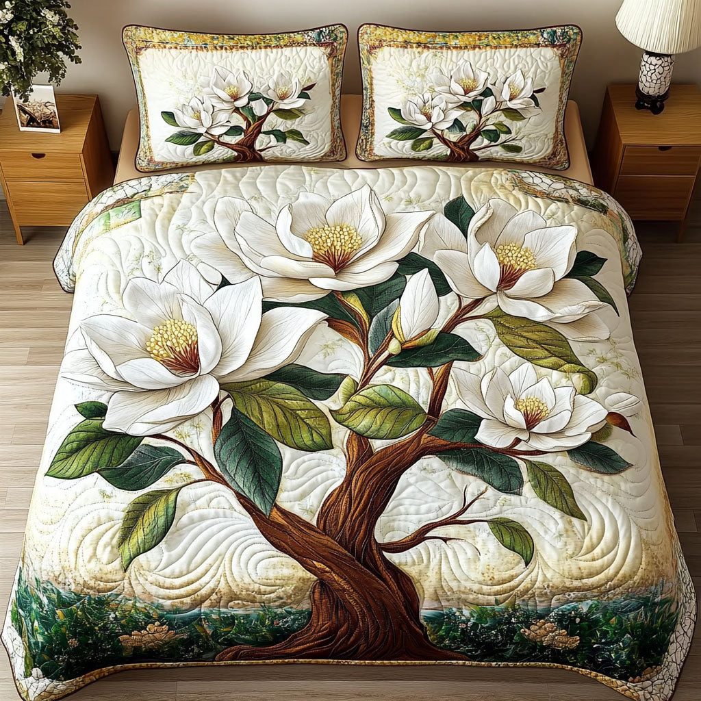 Magnolia Blossom Elegance quilted 3-piece bedding set on a made bed with two matching pillow shams