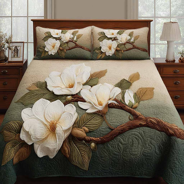Magnolia Majesty quilted 3-piece bedding set on a made bed with two matching pillow shams