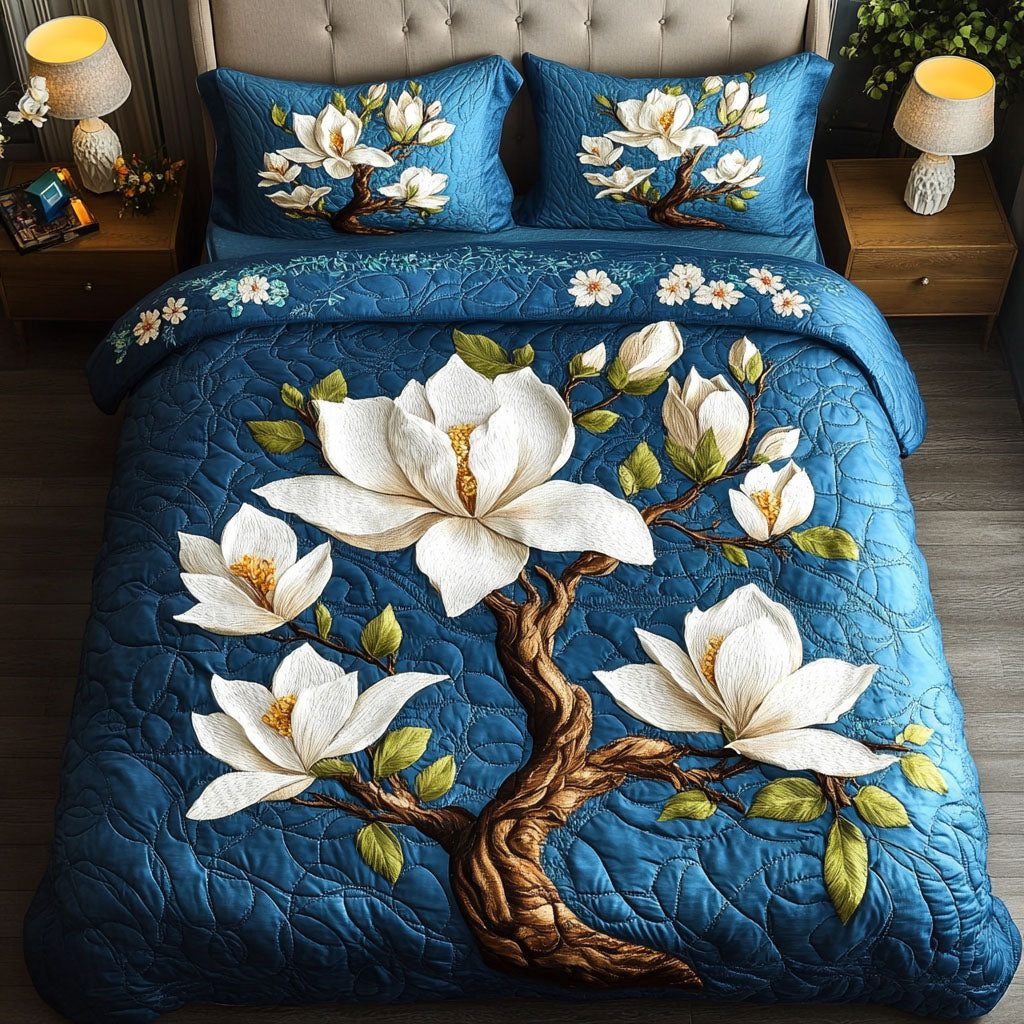 Magnolia Serenity Blue quilted 3-piece bedding set on a made bed with two matching pillow shams