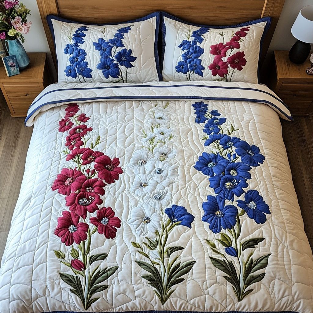 Majestic Delphinium quilted 3-piece bedding set on a made bed with two matching pillow shams