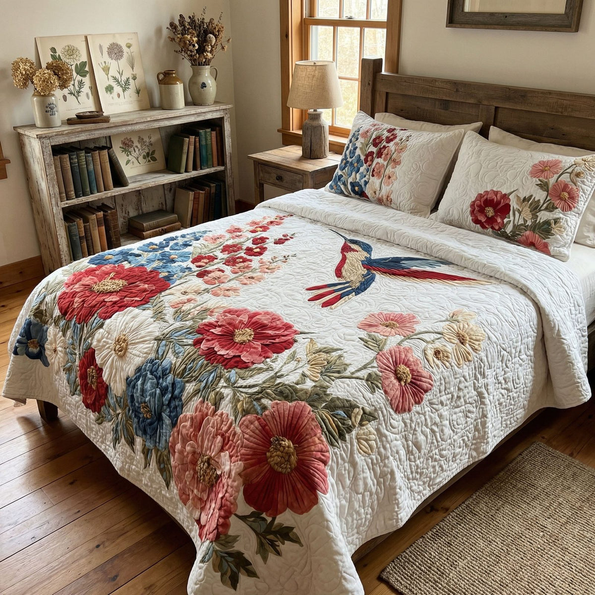 Meadow Hummingbird Haven quilted 3-piece bedding set on a made bed with two matching pillow shams