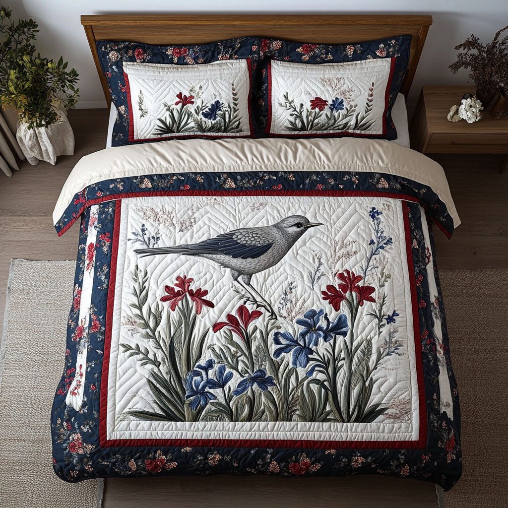 Mockingbird Haven quilted 3-piece bedding set on a made bed with two matching pillow shams