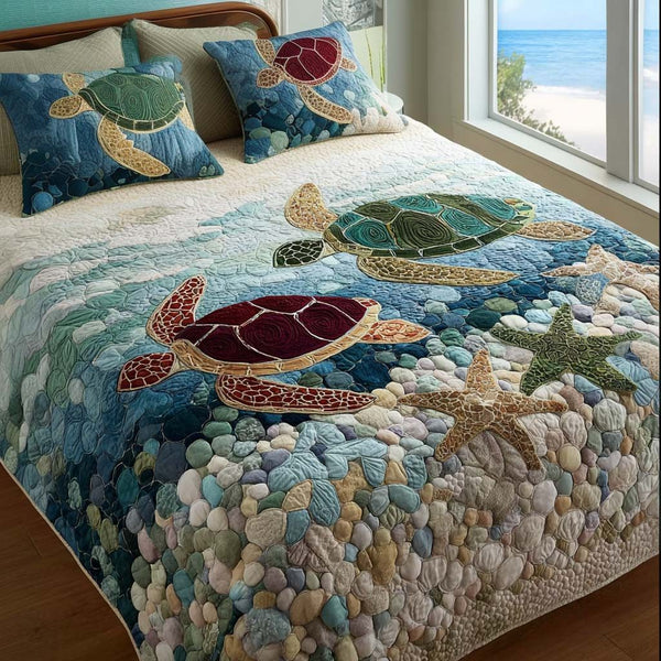 Ocean Wanderer quilted 3-piece bedding set on a made bed in a light coastal bedroom