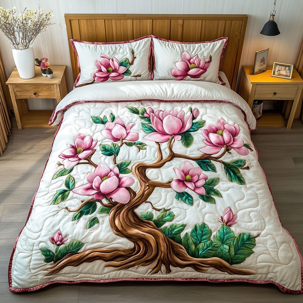Pink Magnolia Dreams quilted 3-piece bedding set on a made bed with two matching pillow shams