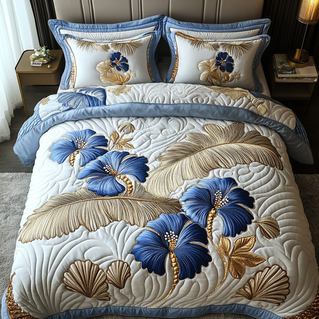 Silver Hibiscus quilted 3-piece bedding set on a made bed with two matching pillow shams