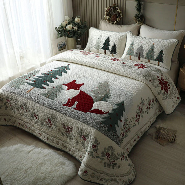 Snow Fox Retreat quilted 3-piece bedding set on a made bed with two matching pillow shams